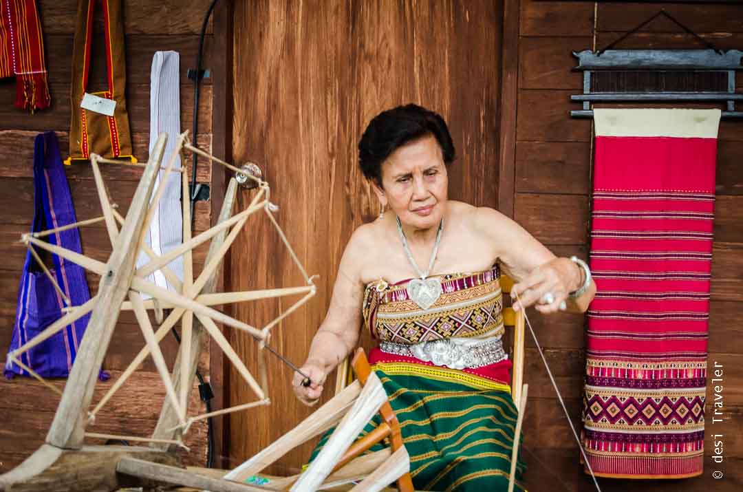 Women working on spinning wheel in Thailand 