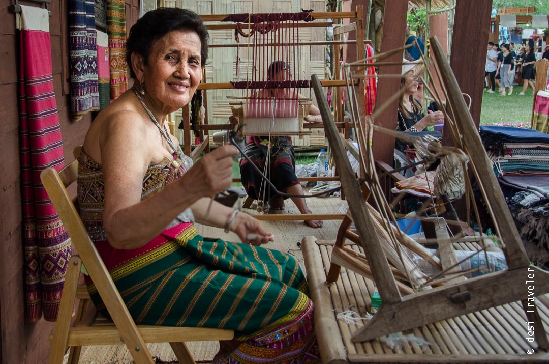 Making Thai fabric using hand loom and spinning wheel